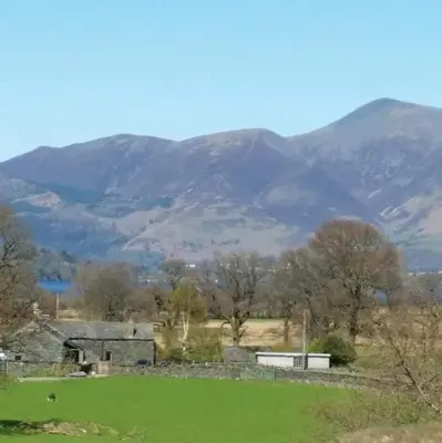 a view of a field with mountains in the background at Lake District, Mountain Views, Accessible Studio Bothy in Borrowdale Valley
