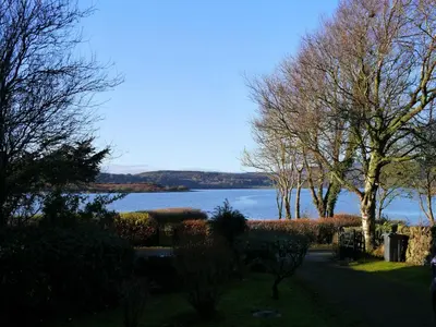 a view of a body of water with trees at Calluna Cottage in Rockcliffe