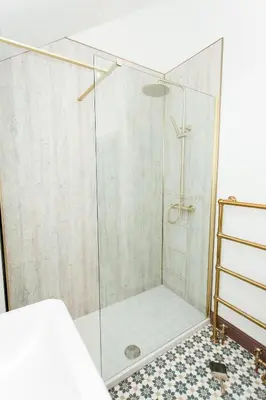 a shower with a glass door in a bathroom at Torr House Hotel in Dumfries