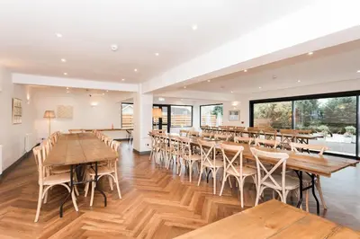a dining room with wooden tables and chairs at Torr House Hotel in Dumfries