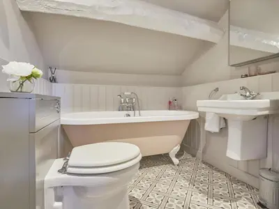 a bathroom with a tub and a toilet and a sink at 5 Bed in Cockermouth oc-sz424 in Lorton