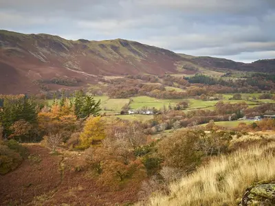 a view of a valley with trees and mountains at 5 Bed in Cockermouth oc-sz424 in Lorton