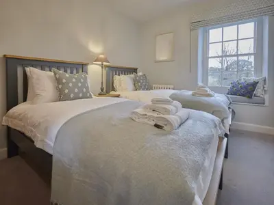 two beds in a bedroom with towels on them at 5 Bed in Cockermouth oc-sz424 in Lorton