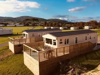 a modular home with a wrap around deck at Konkers in Girthon