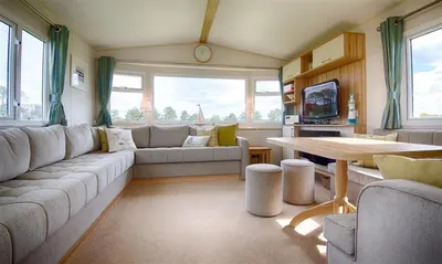 a living room with a couch and a table at Konkers in Girthon