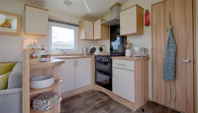 a small kitchen with a sink and a stove at Konkers in Girthon