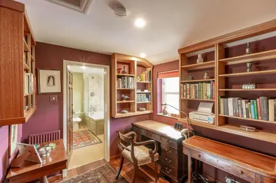 a home office with a desk and bookshelves at Lochpatrick Mill in Castle Douglas