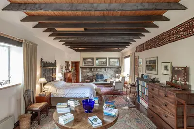 a bedroom with a bed and a wooden ceiling at Lochpatrick Mill in Castle Douglas