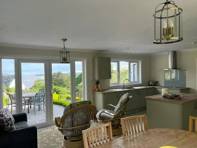 a kitchen and living room with a table and chairs at Lonsdale in Rockcliffe