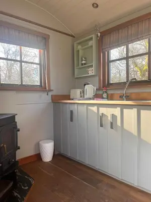 a kitchen with white cabinets and a stove at Highland Hideaway in Wigton