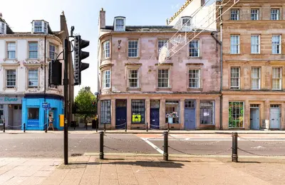 a traffic light on a city street with buildings at Sea Ayr - City Centre Apartment in Ayr