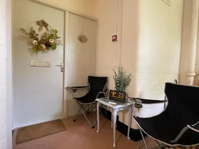 a room with two chairs and a table and a door at No23 - Bright & spacious 2nd floor flat - PET friendly - Noon check out in Stanwix