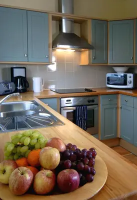 a plate of fruit on a table in a kitchen at Barcloy Milk House in Kirkcudbright