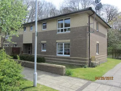 a brick house with a pole in front of it at Portpatrick 2 bedroom Self Catering Flat in Portpatrick