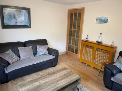 a living room with a couch and a table at Portpatrick 2 bedroom Self Catering Flat in Portpatrick
