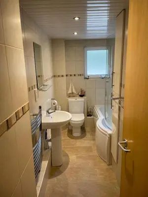 a bathroom with a sink and a toilet and a tub at Portpatrick 2 bedroom Self Catering Flat in Portpatrick