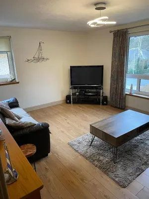 a living room with a couch and a flat screen tv at Portpatrick 2 bedroom Self Catering Flat in Portpatrick