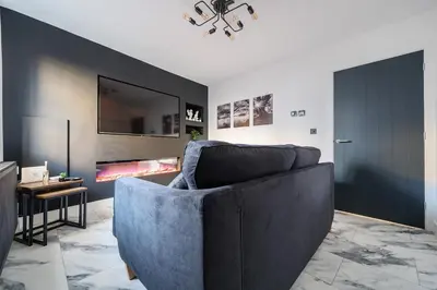 a living room with a couch and a fireplace at Modern Town House In Cockermouth in Cockermouth