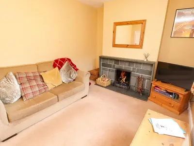 a living room with a couch and a fireplace at Maiden Moor in Keswick
