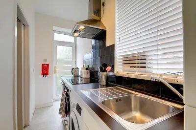 a kitchen with a sink and a counter top at Apartment Caerlaverock Road in Prestwick