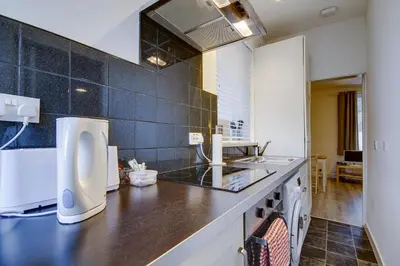 a kitchen with a sink and a counter top at Apartment Caerlaverock Road in Prestwick