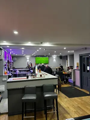 a bar in a restaurant with people sitting at tables at The Cassillis Hotel - Smart Self Check-in Hotel & Bar in Maybole