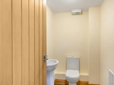 a bathroom with a toilet and a door at Turnip House - Uk48909 in Allonby