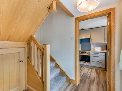 a staircase leading up to a kitchen in a house at Turnip House - Uk48909 in Allonby