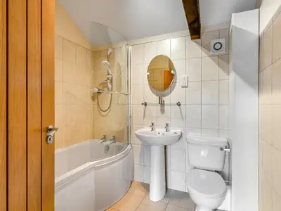 a bathroom with a sink and a toilet and a bath tub at Turnip House - Uk48909 in Allonby