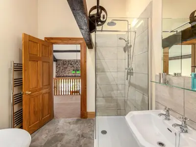 a bathroom with a shower and a tub and a sink at Barley Store - Uk48910 in Allonby