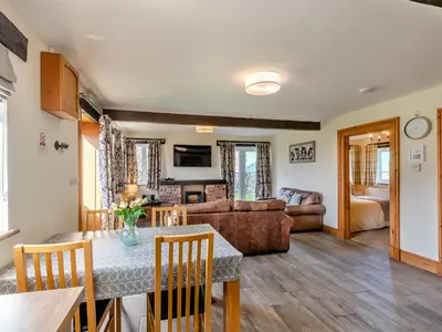 a living room with a table and a couch at Milking Parlour - Uk48911 in Allonby