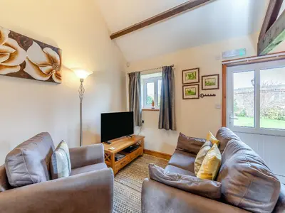 a living room with two couches and a flat screen tv at Eight Byre - Uk48913 in Allonby