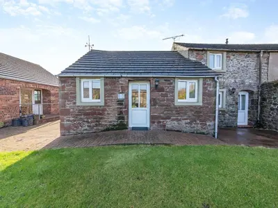 a brick house with a large lawn in front of it at Eight Byre - Uk48913 in Allonby