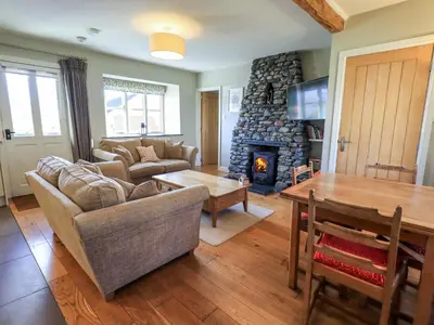a living room with a couch and a fireplace at Fox Howe in Keswick