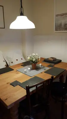 a wooden table with a potted plant on top of it at Rose cottage on the peaceful solway coast in Port Carlisle