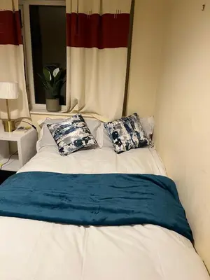 a bed with two pillows on it with a window at IFYLOVESITt2 in Moffat