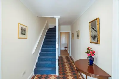 a staircase in a house with blue steps at Ornockenoch House in Gatehouse of Fleet