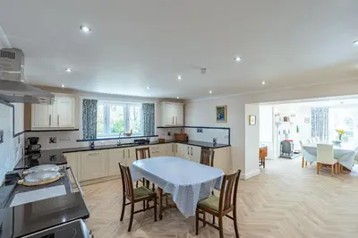 a kitchen and dining room with a table and chairs at Ornockenoch House in Gatehouse of Fleet
