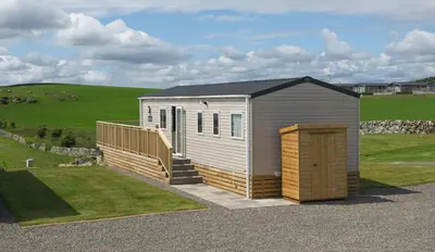 a tiny house sitting on the side of a road at Pebbles in Girthon