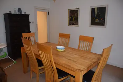 a dining room table with chairs and a bowl on it at Rocklea in Kippford