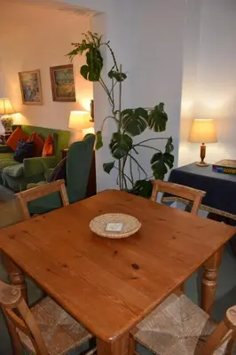 a wooden table in a living room with plants at Rocklea in Kippford