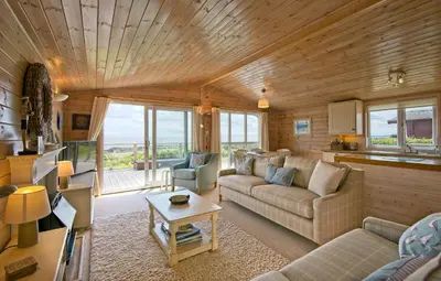 a living room with a couch and a table at The Buoys in Girthon