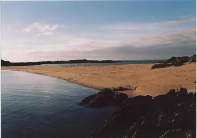 a beach with rocks and the water and the ocean at The Buoys in Girthon
