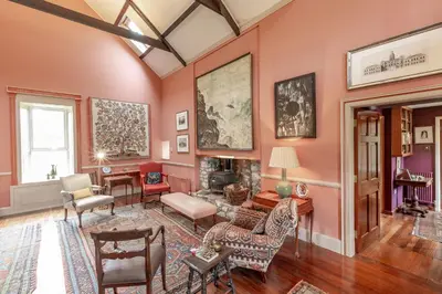 a living room with pink walls at The Mill in Castle Douglas