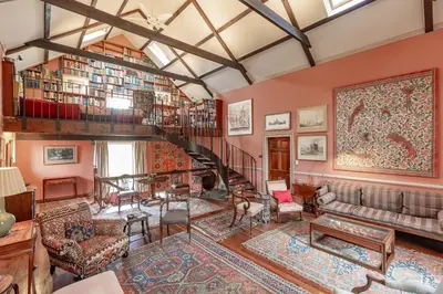 a living room filled with furniture and a spiral staircase at The Mill in Castle Douglas