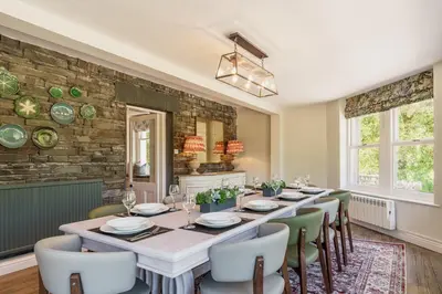 a dining room with a long table and chairs at Leathes Head Country House in Keswick