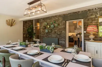 a dining room with a long table and chairs at Leathes Head Country House in Keswick