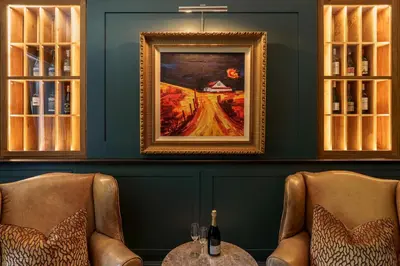 a dining room with two chairs and a painting at Leathes Head Country House in Keswick