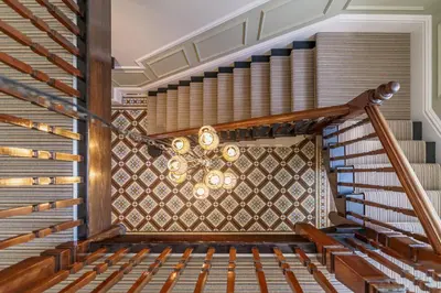 a spiral staircase in a building with a chandelier at Leathes Head Country House in Keswick