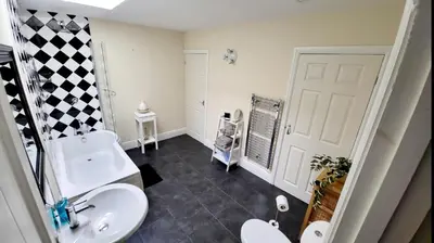 a bathroom with a white toilet and a sink at Hicks Central - Sleeps 2 in Whitehaven